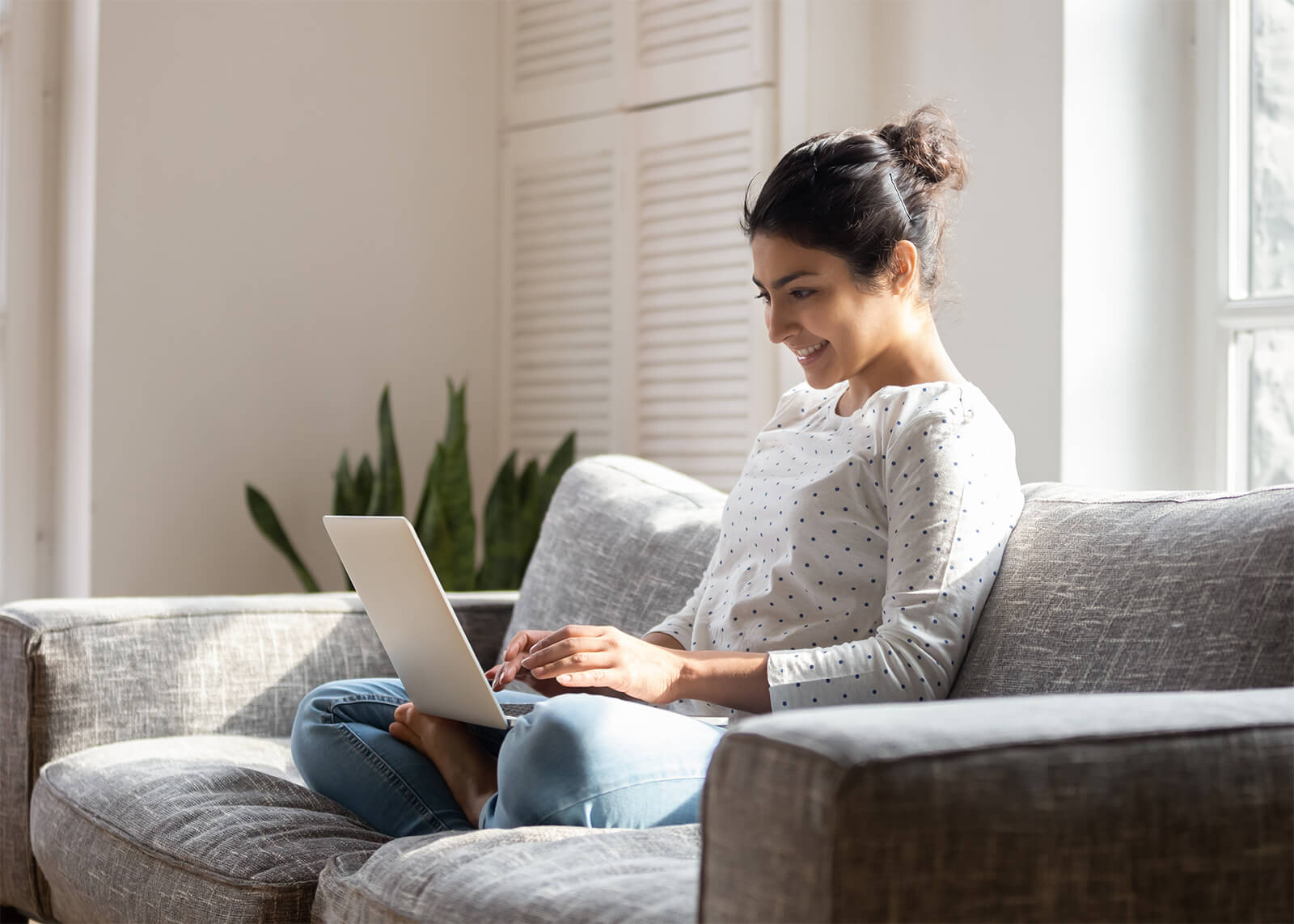 Young woman looking up reviews for eye doctors in Livingston, NJ