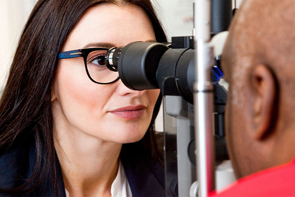 Ophthalmologist giving eye exam
