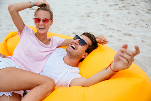 Young couple enjoying the beach after LASIK