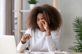 Woman rubbing her irritated eyes