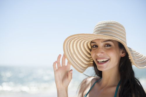Woman on beach smiling at camera 