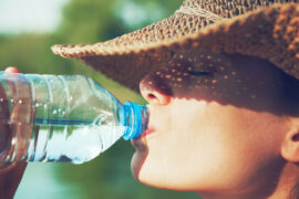 Woman drinking water on a sunny day