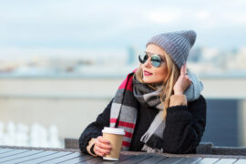 Woman outside with warm drink on a cold day